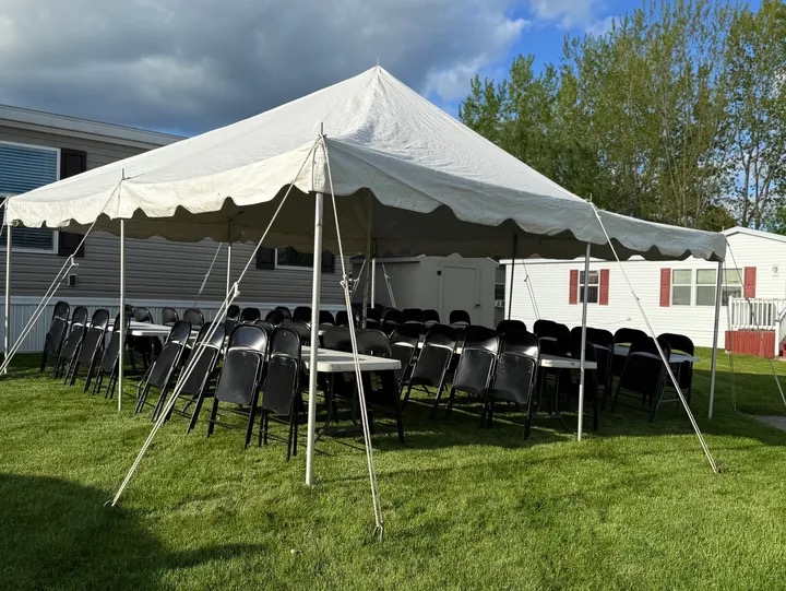 20x20 white pole tent setup for a backyard party rental in Flint MI
